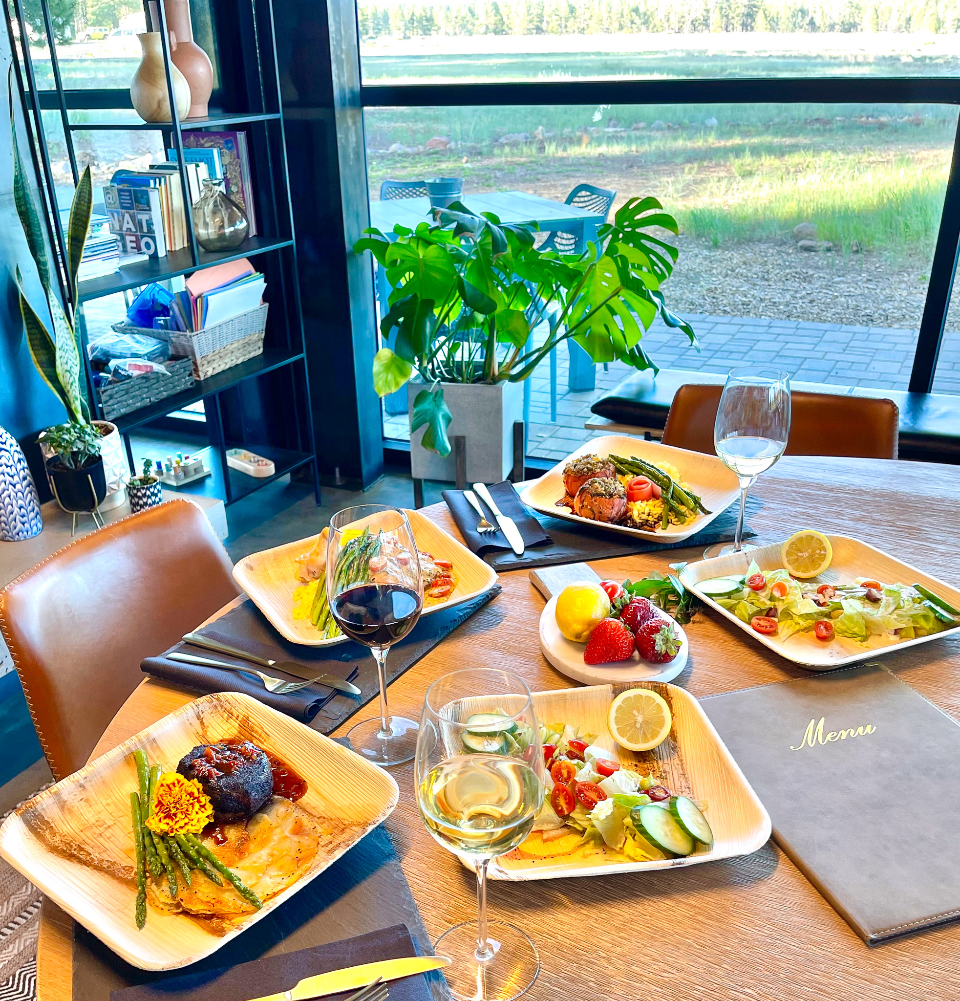 A table set with dinner at a nice restaurant.
