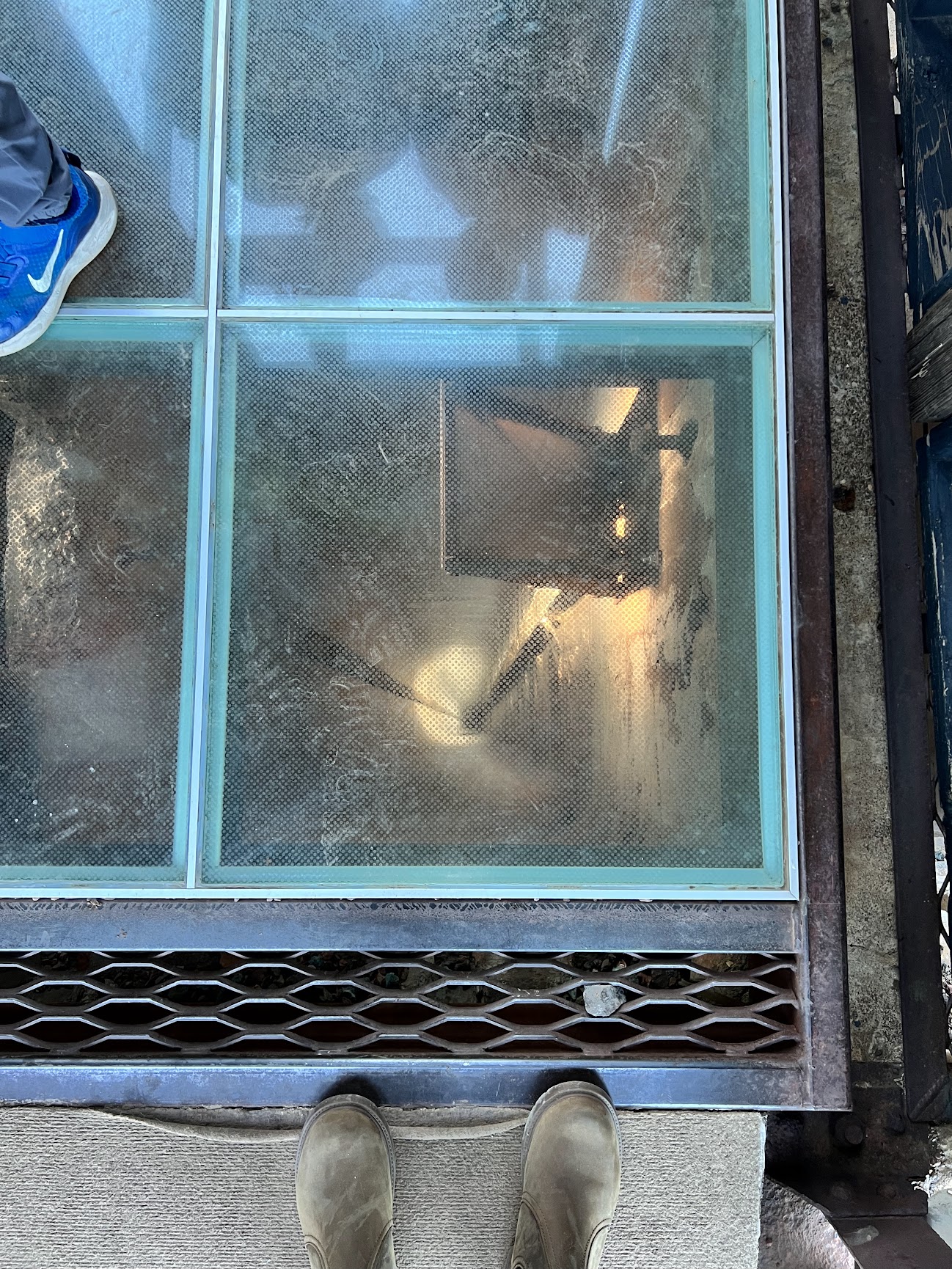 Looking down into a mine shaft through a plexiglass floor