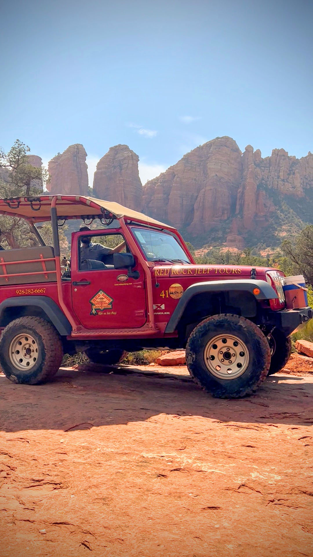 Red Rock Jeep Tours jeep with rock formations in Sedona, Arizona.